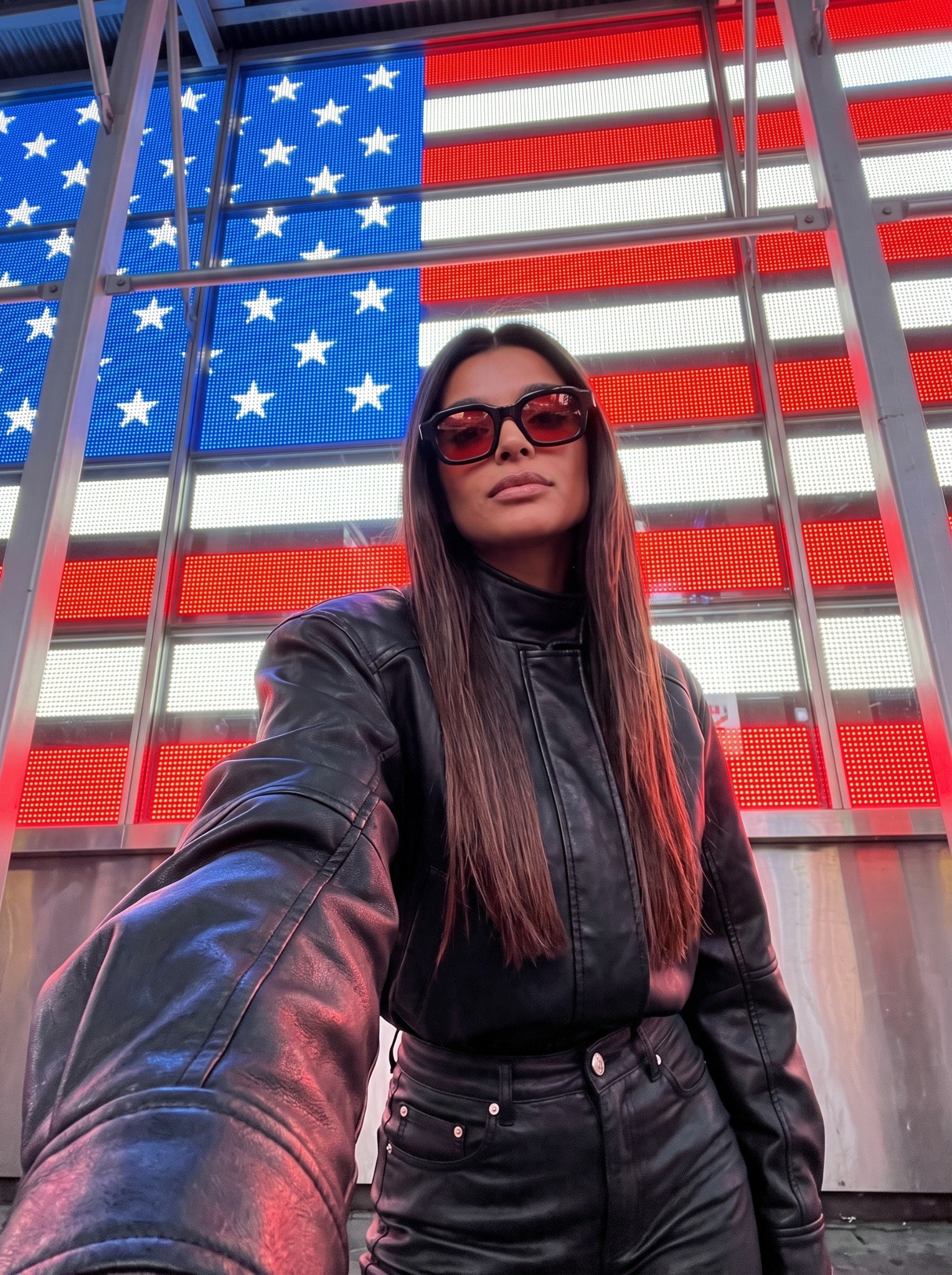 Sofia Whitmore wearing CHROMA 01 red-lens sunglasses with black leather