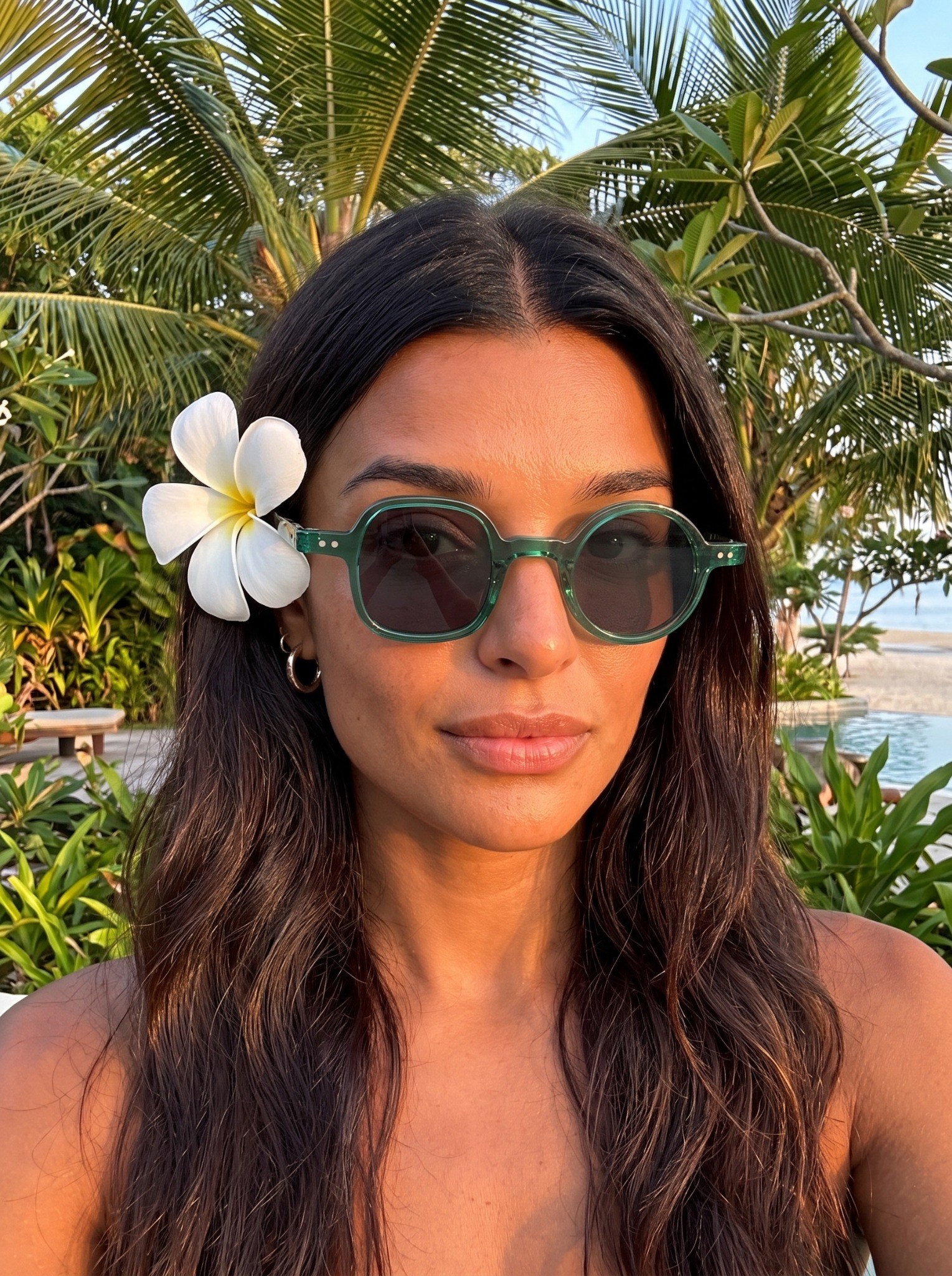 Sofia Whitmore wearing PARALLAX 01 sunglasses in tropical golden-hour light
